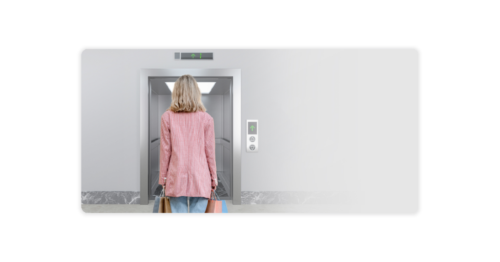 woman carrying shopping bags entering elevator door 