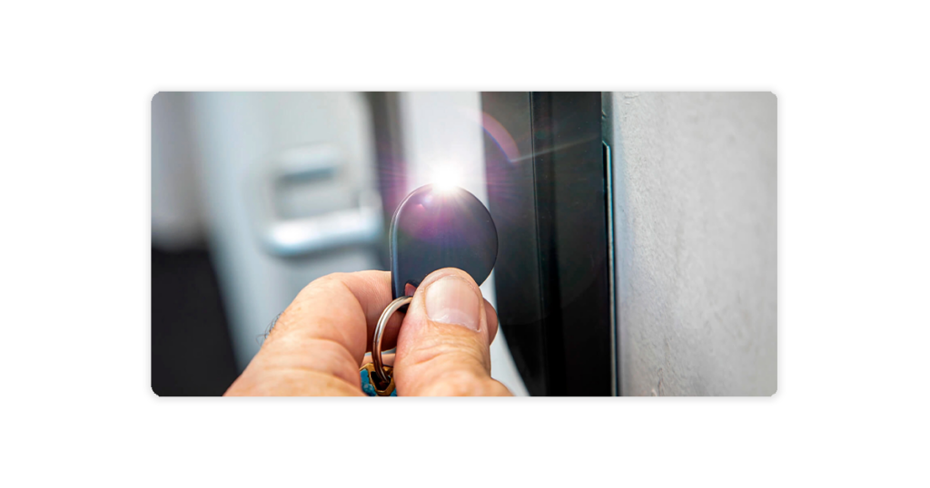 person using access control key fob on access control card reader terminal